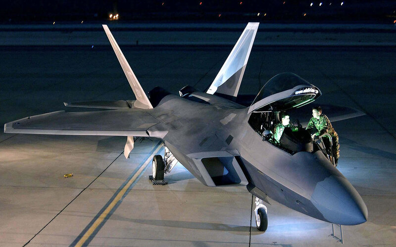 F-22 Raptor on tarmac at night
