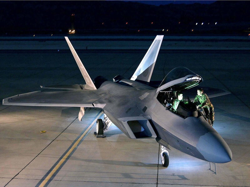 F-22 Raptor on tarmac at night