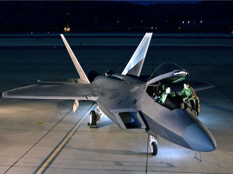 F-22 Raptor on tarmac at night