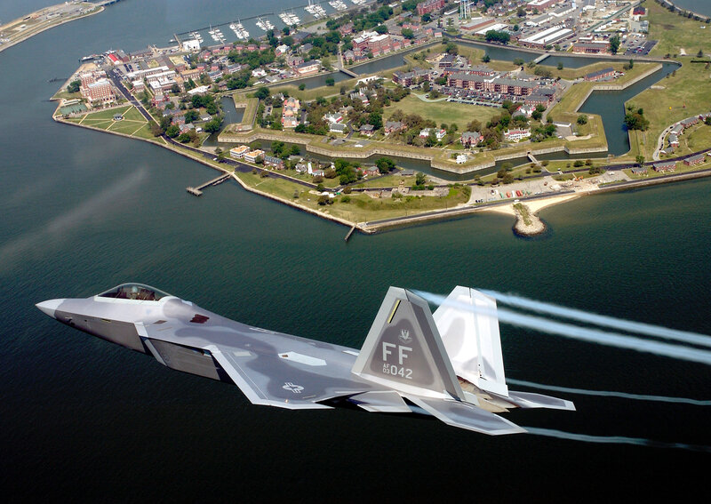 F-22 Raptor over a coastal fort