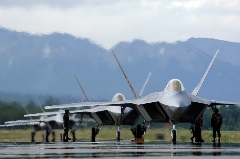 F-22 Raptors on a wet tarmac