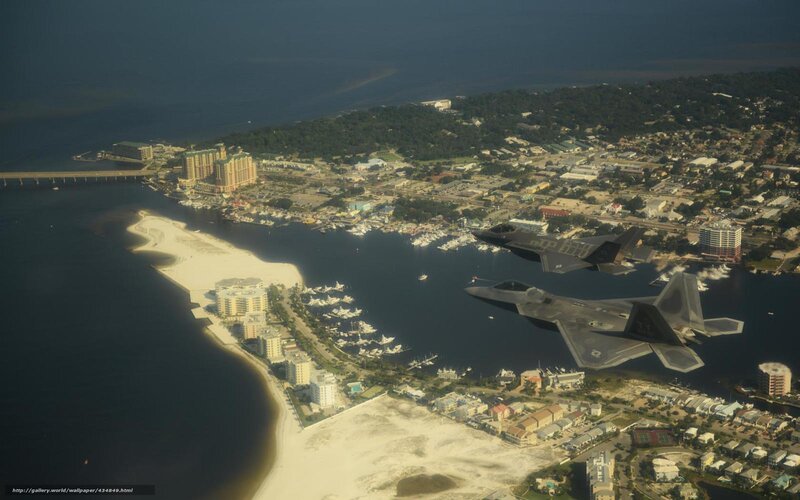 F-22 Raptors over coastal city