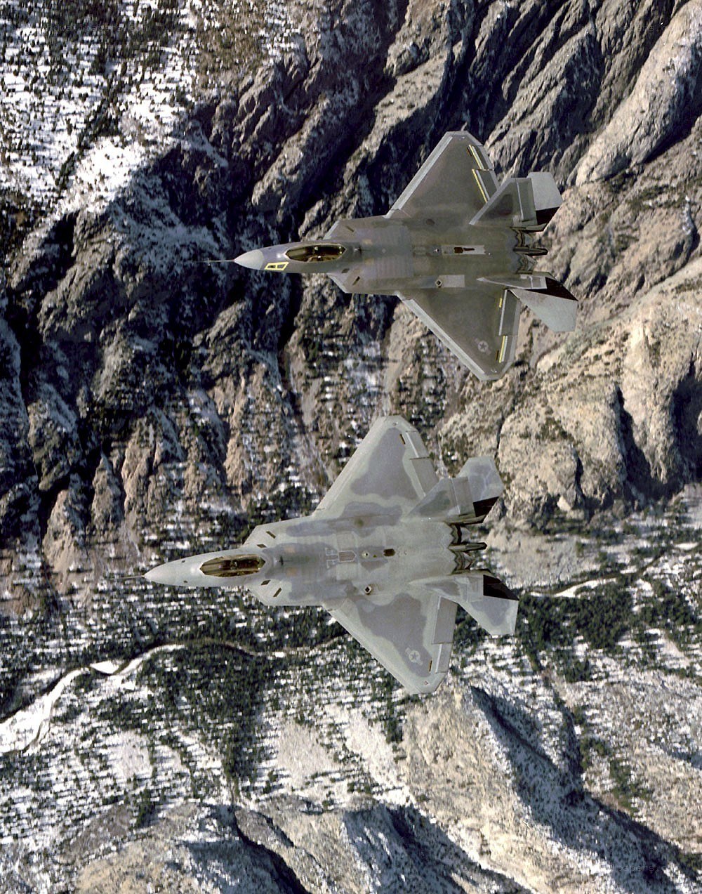 F-22 Raptors over mountains