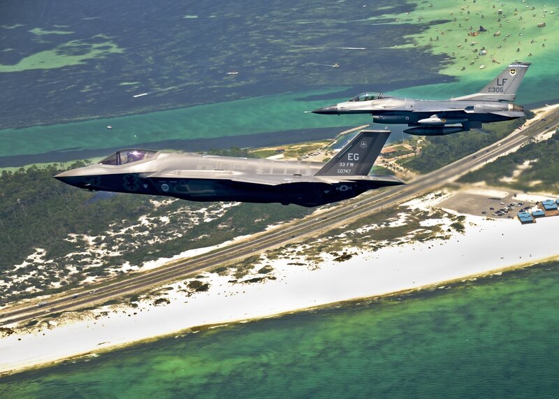 F-35 and F-16 flying over coast