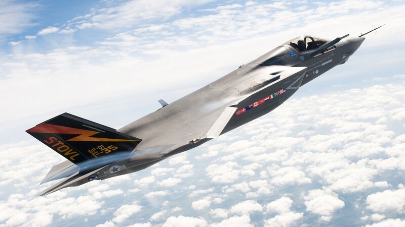 F-35 Fighter Jet — Gray, Dramatic, Afternoon, Photograph, Clouds, Sky, Flags