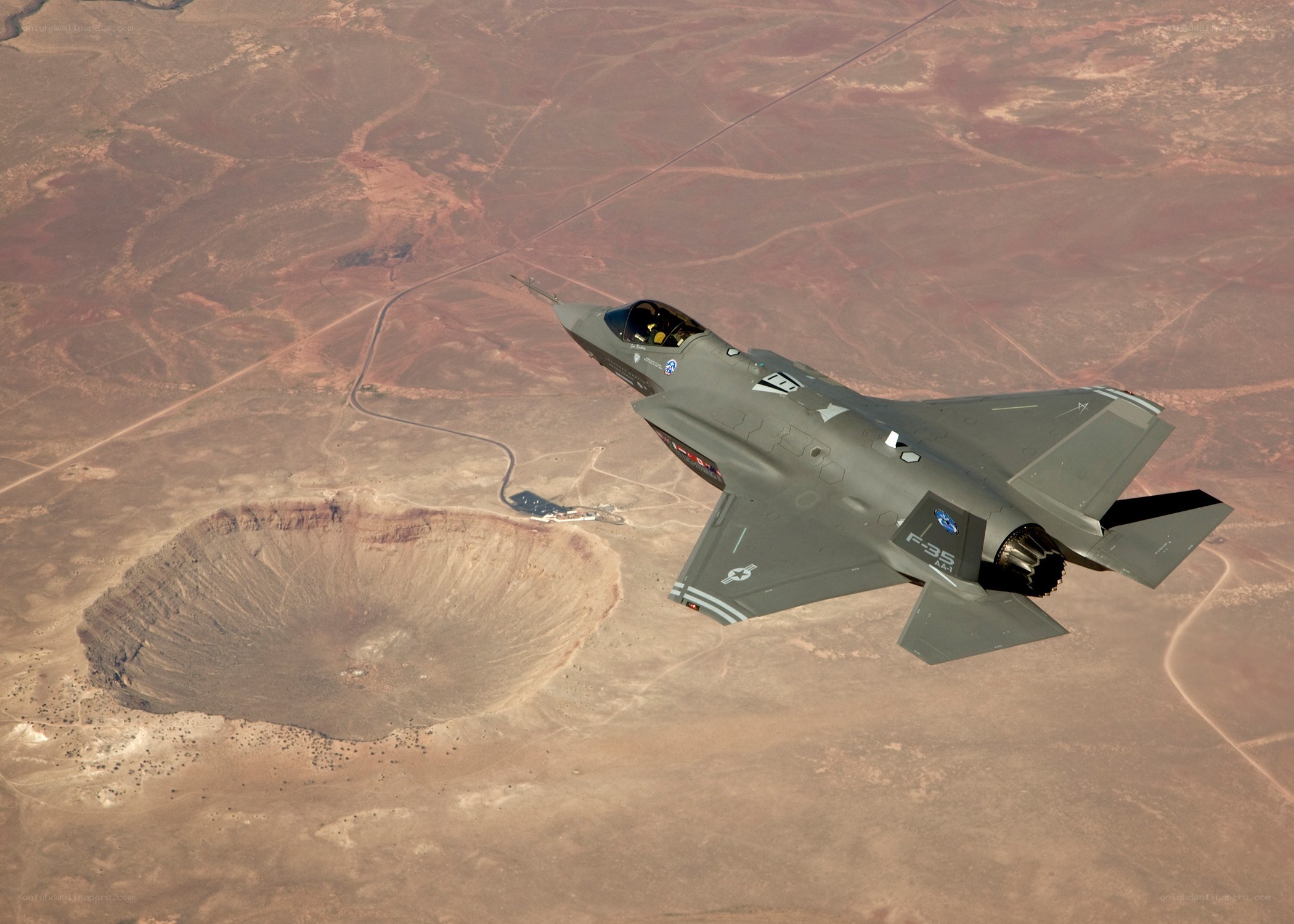 F-35 flying over crater