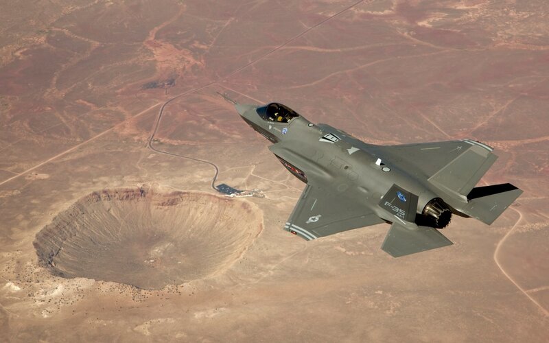 F-35 flying over crater