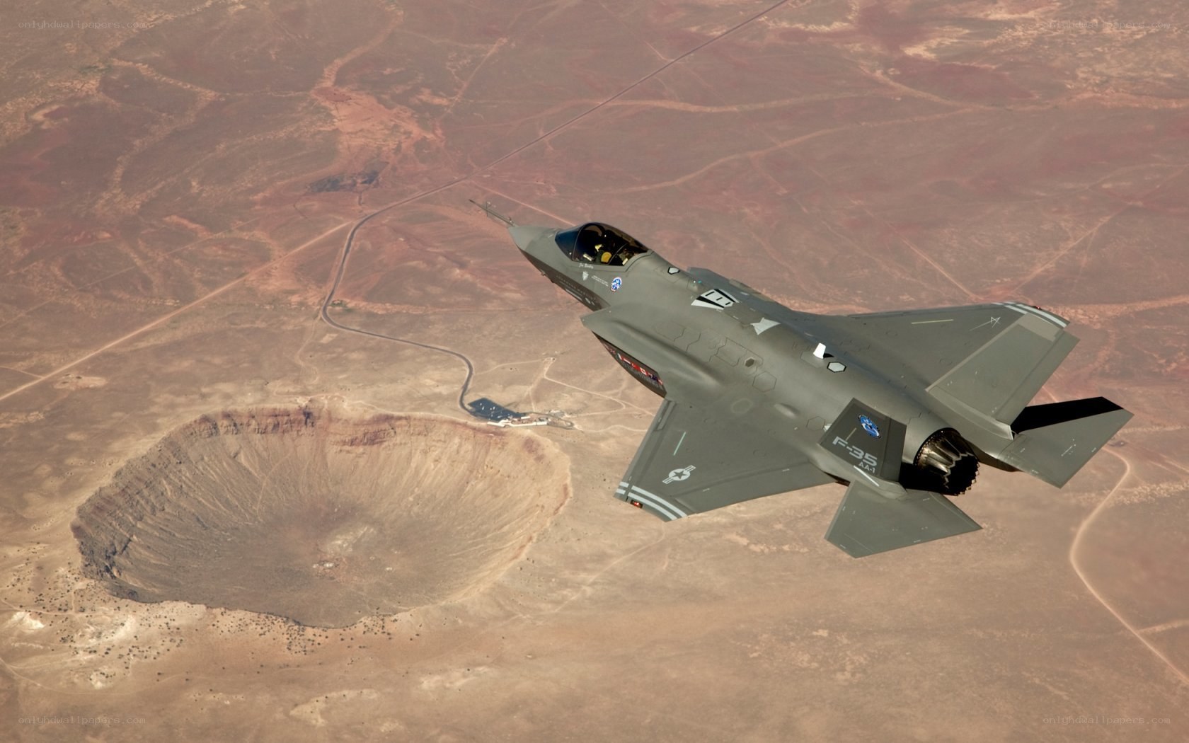 F-35 flying over crater