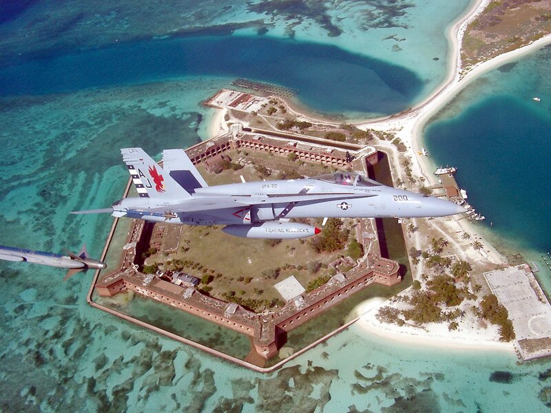 F/A-18 over a coastal fort
