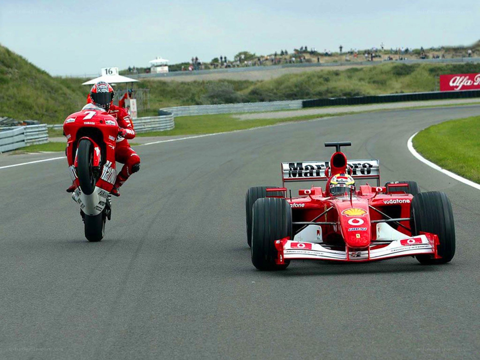 F1 car and motorcycle on track