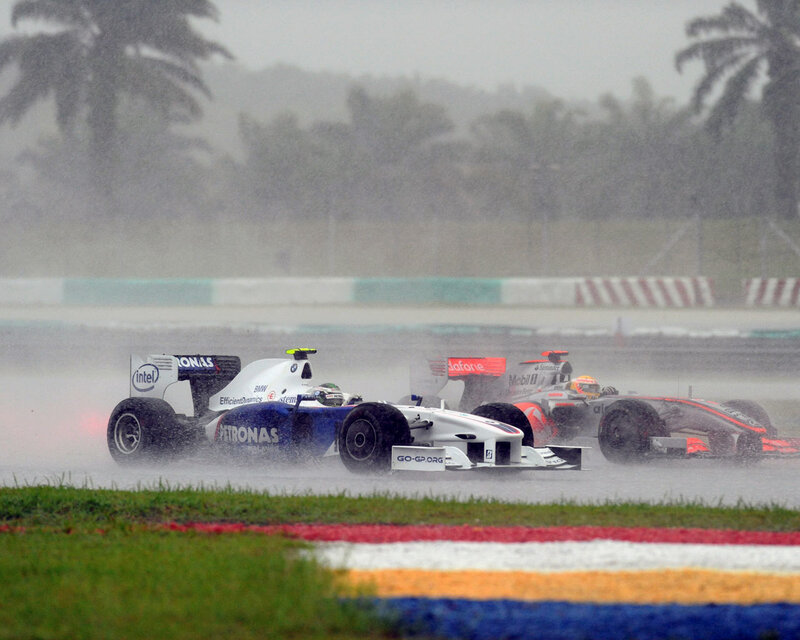 F1 cars racing in rain