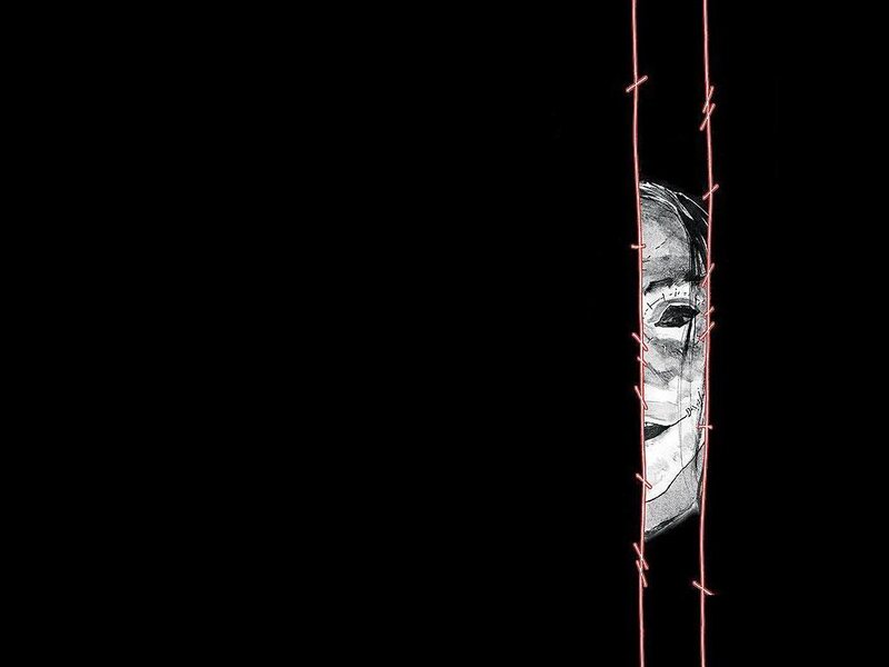 face behind barbed wire