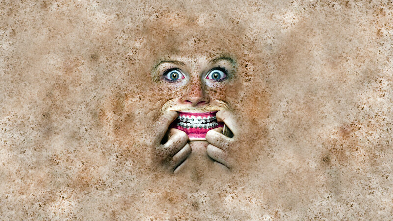 Face Emerging from Sand — Brown