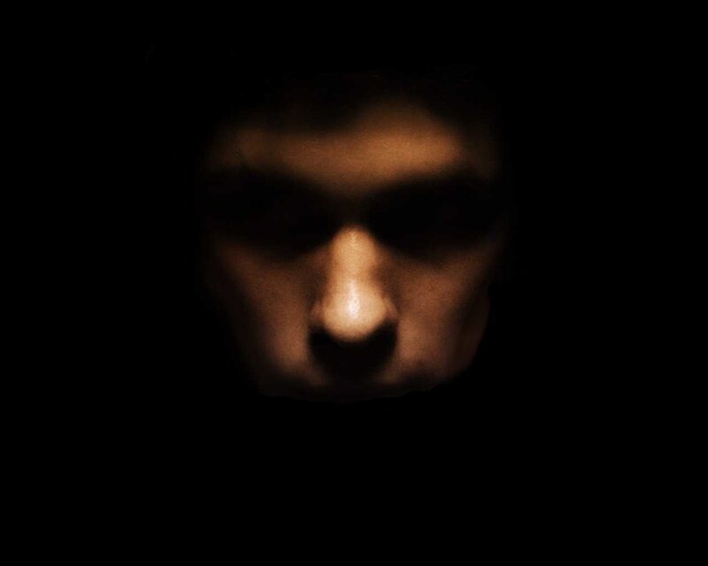 face in darkness