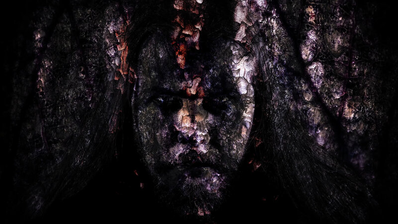 Face in Decaying Bark