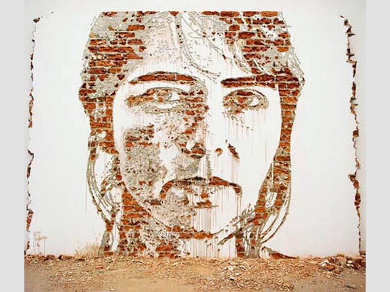 Face on Brick Wall