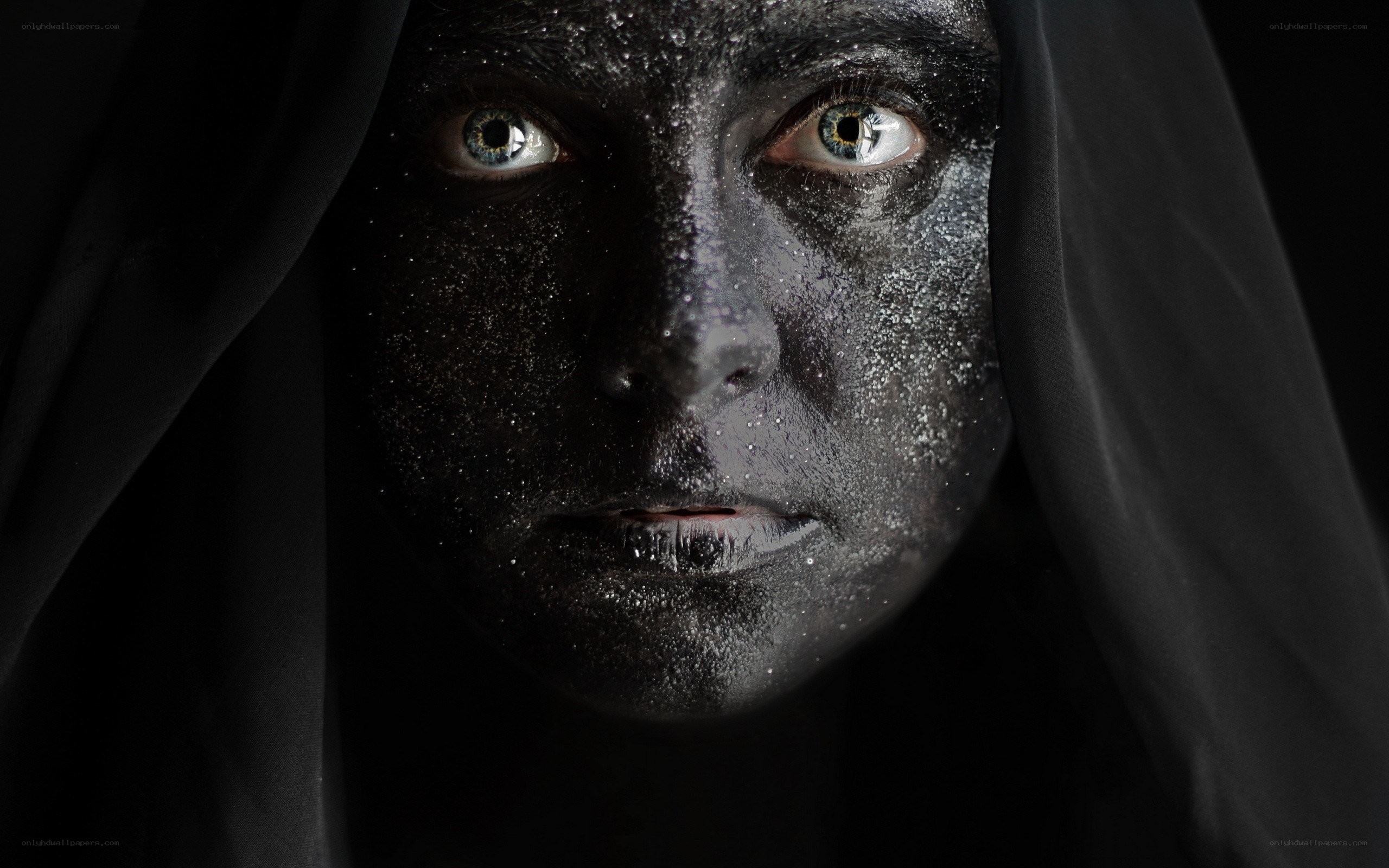face with black paint and hood