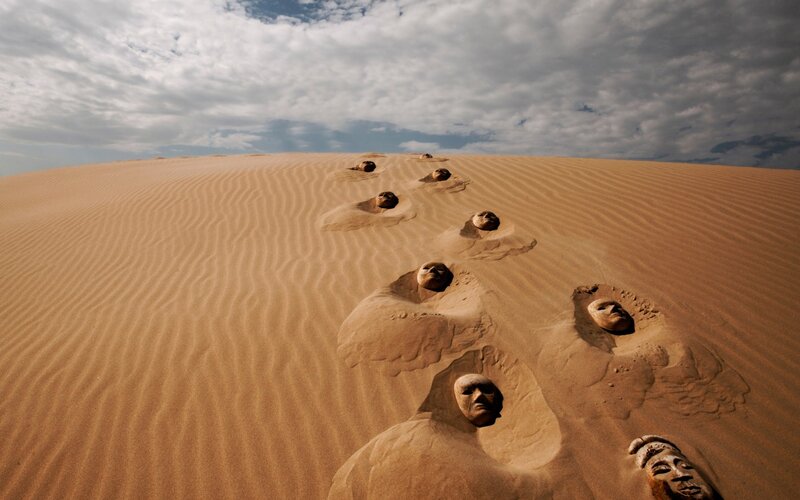 Faces Buried in Sand