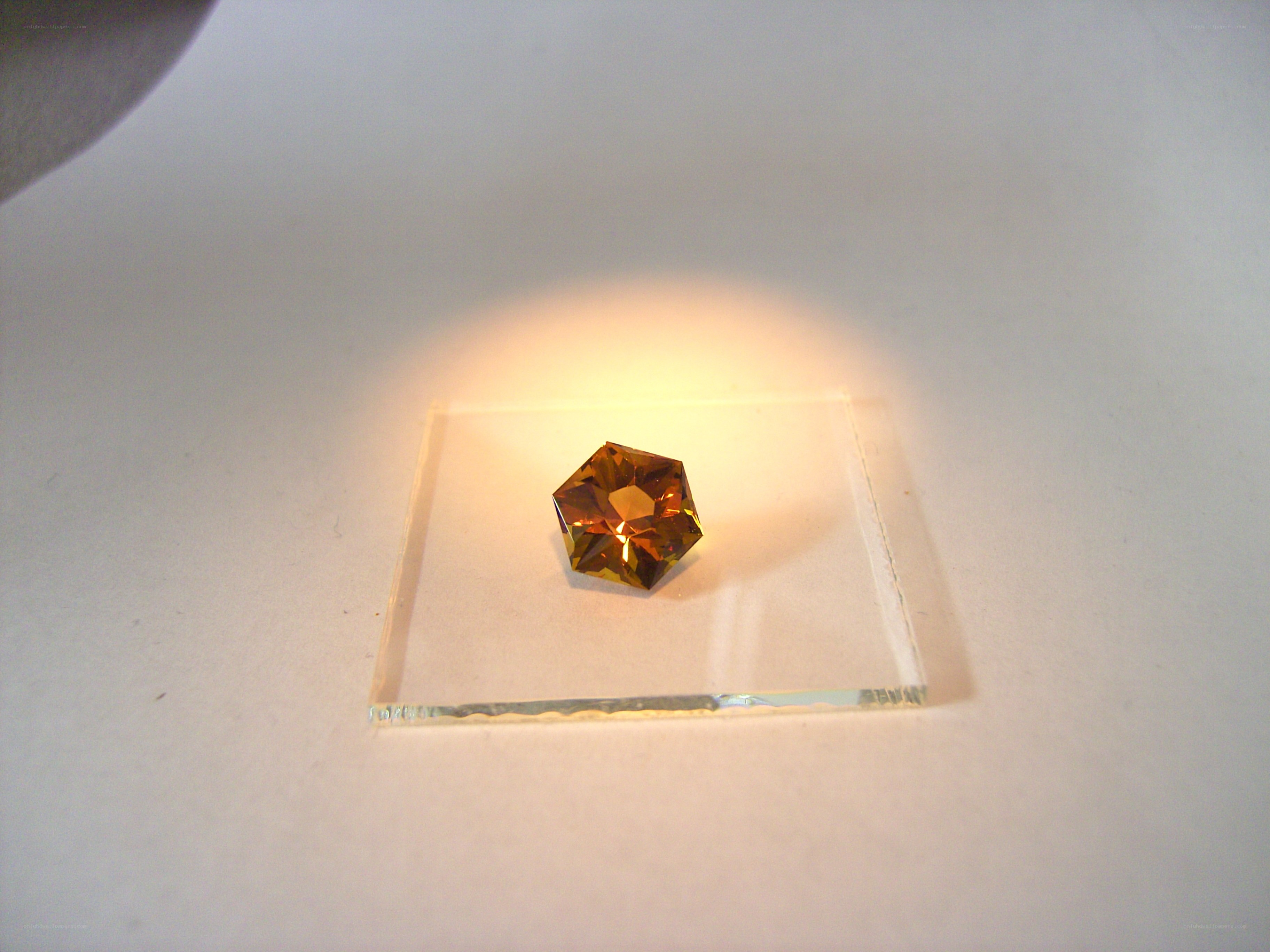 Faceted amber gemstone on glass