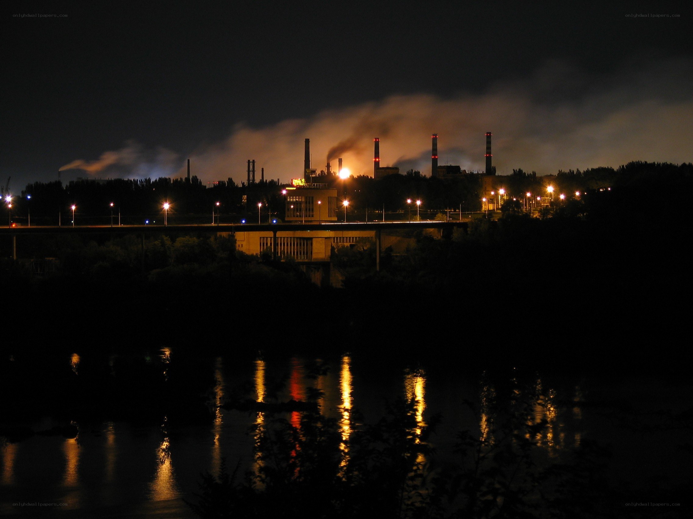 Factory at night by the river