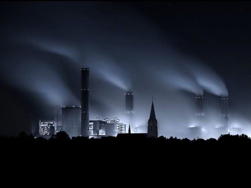 Factory at night with smoke