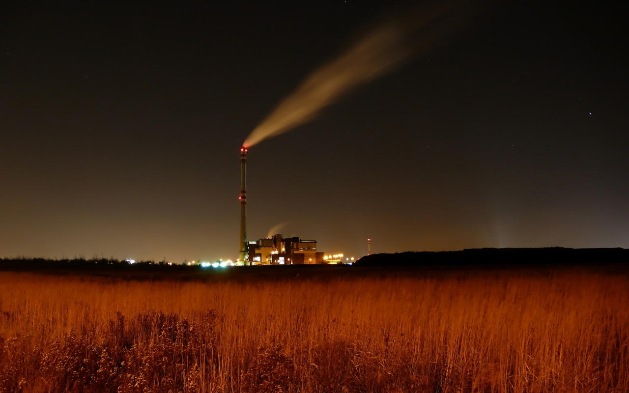 Factory at night with smoke