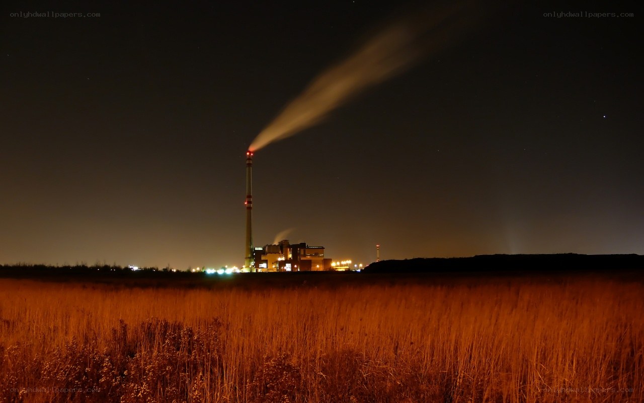 Factory at night with smoke