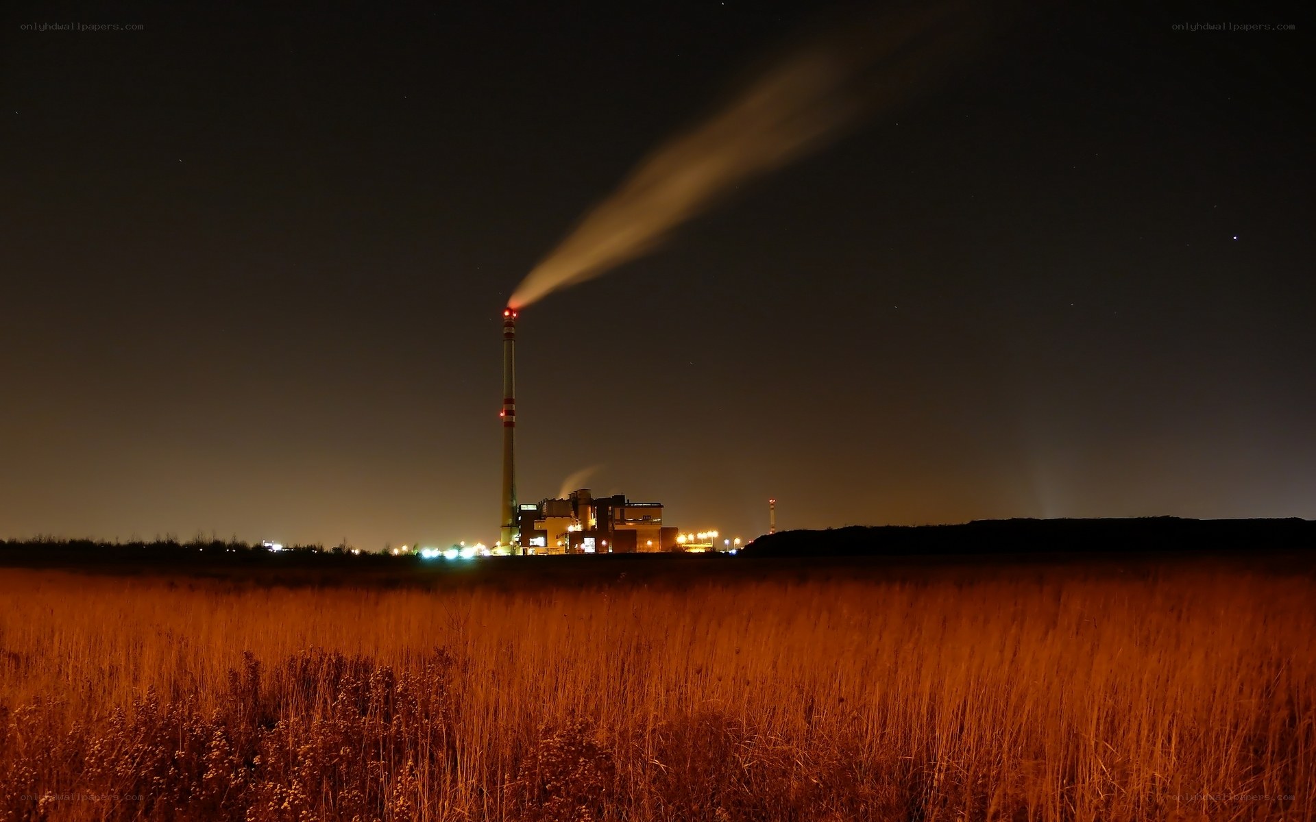 Factory at night with smoke