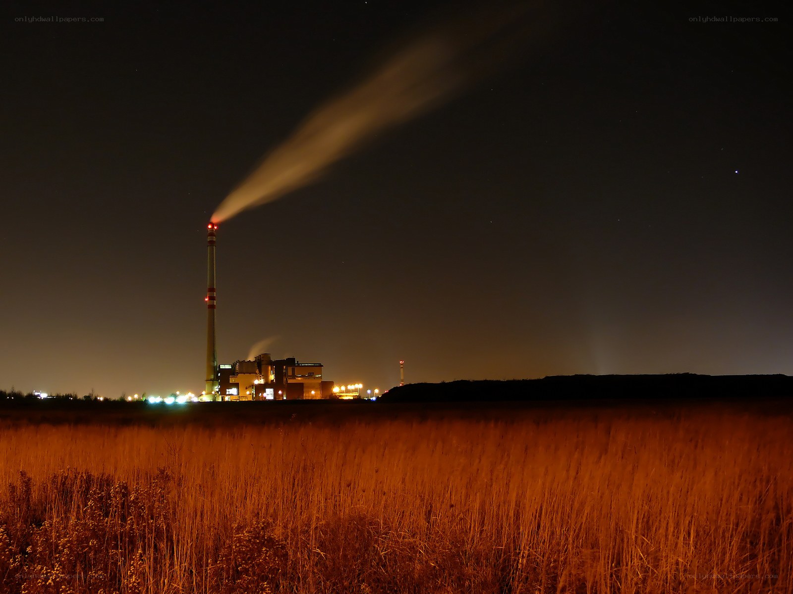 Factory at night with smoke