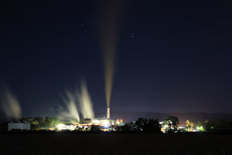 Factory at night with smoke