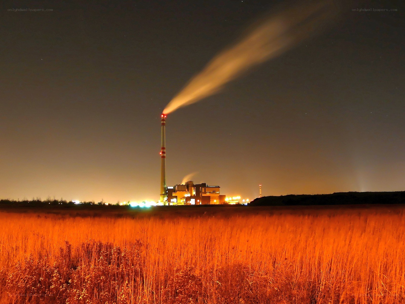 Factory at night with smoke