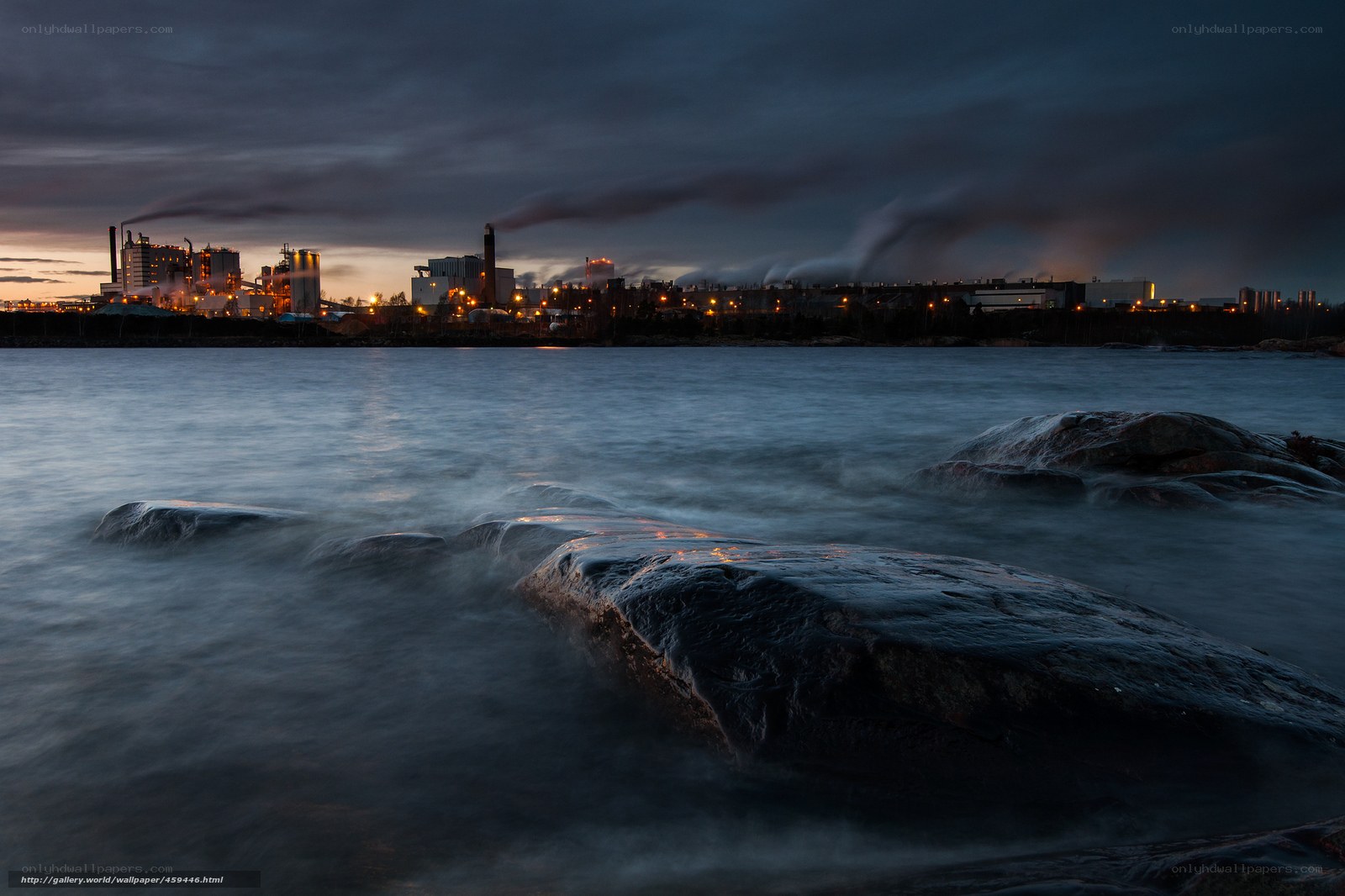 Factory by the water at dusk