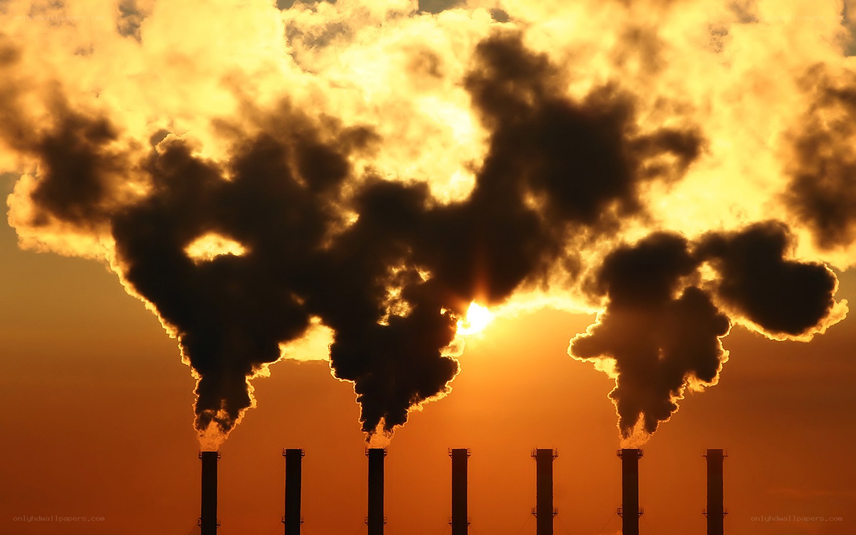 Factory smoke at sunset