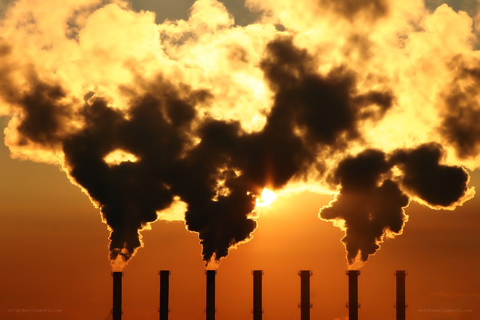 Factory smoke at sunset