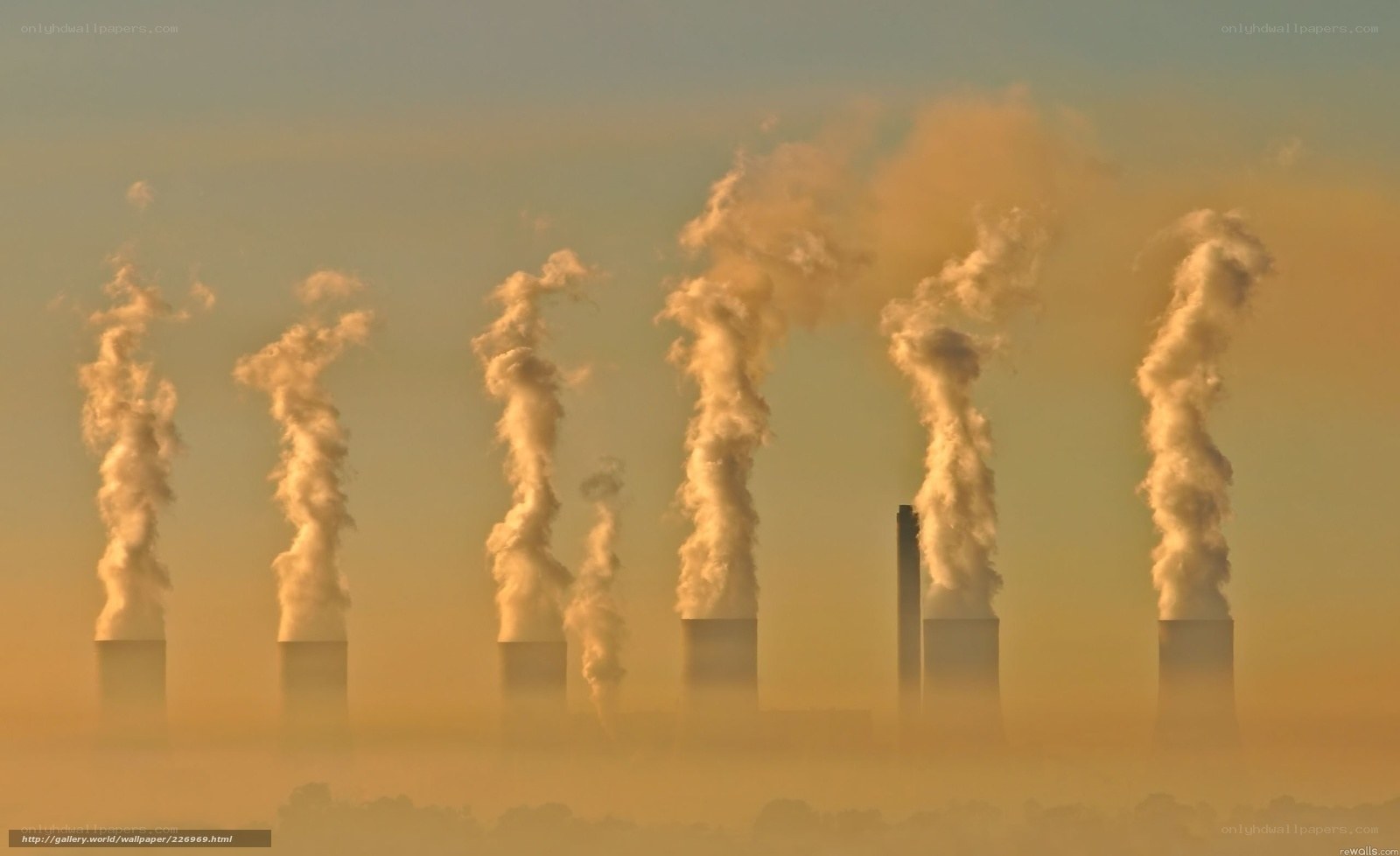 Factory smokestacks at sunrise