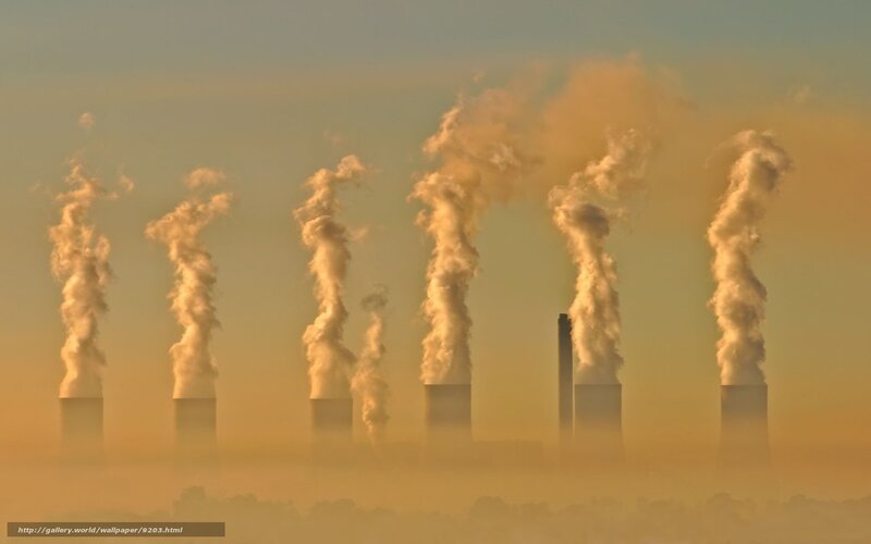 Factory smokestacks at sunrise