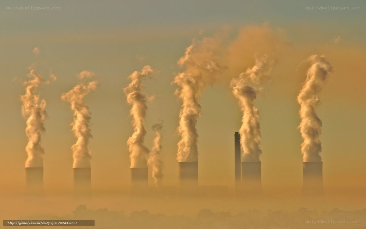 Factory smokestacks at sunrise