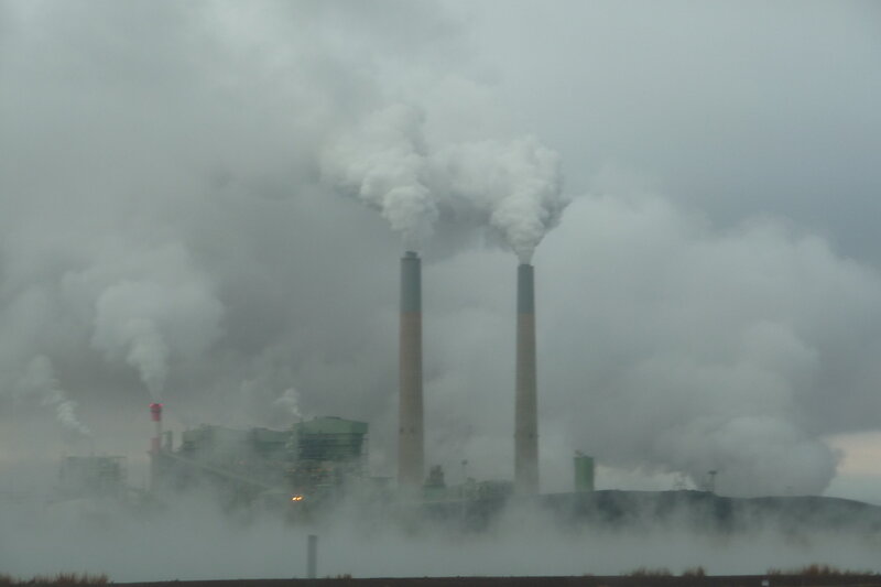 Factory with smokestacks emitting emissions
