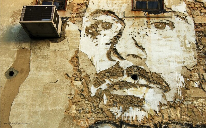 faded mural on weathered wall