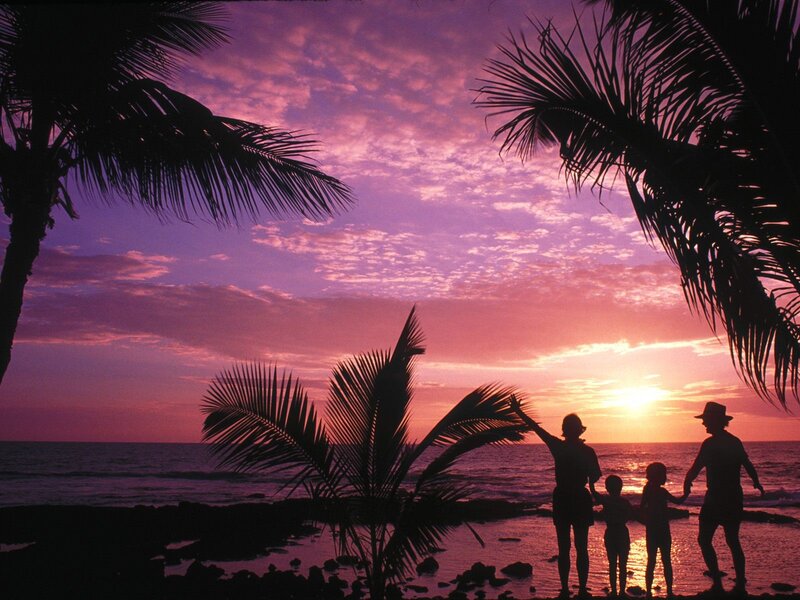 Family at sunset on tropical beach