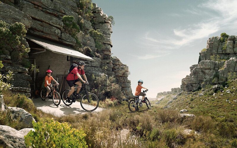 Family biking in rocky landscape