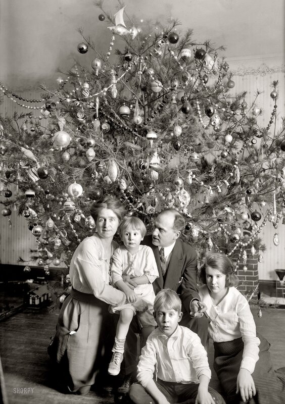 Family by Christmas tree