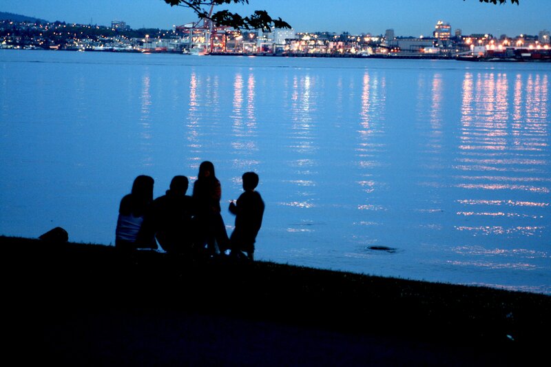 Family by the water at dusk