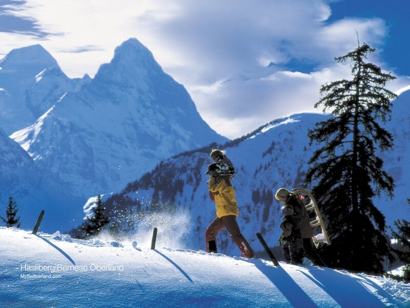 Family hiking in snowy mountains