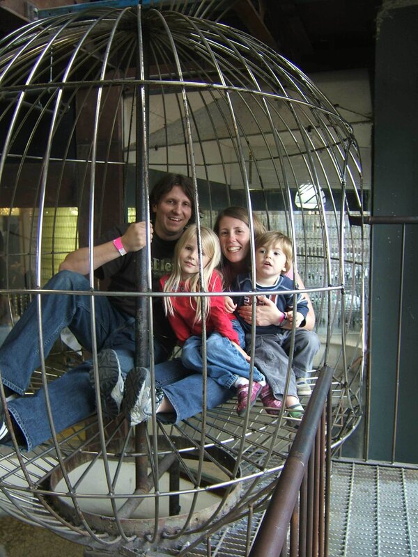 Family in a birdcage exhibit