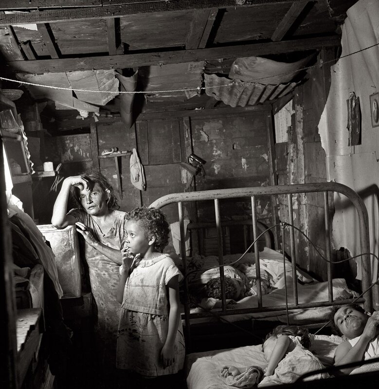 Family in a dilapidated room