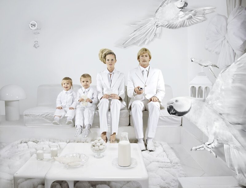 Family in a white room with birds