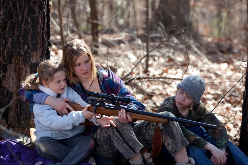 Family in forest with rifle