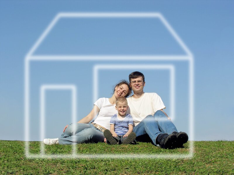 Family in front of house outline