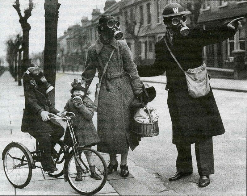 Family in gas masks on street